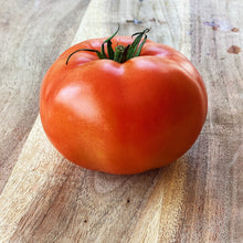 Load image into Gallery viewer, single beefsteak tomato on a wooden board
