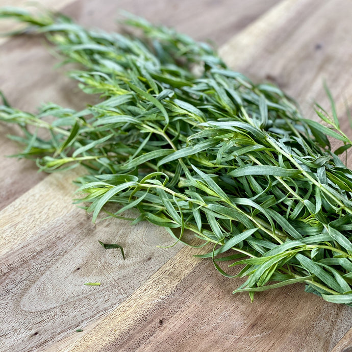 fresh bunch of tarragon on a wooden board