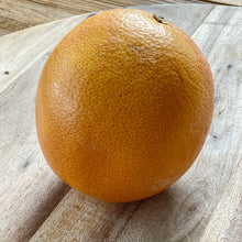 Load image into Gallery viewer, whole yellow grapefruit on a wooden board
