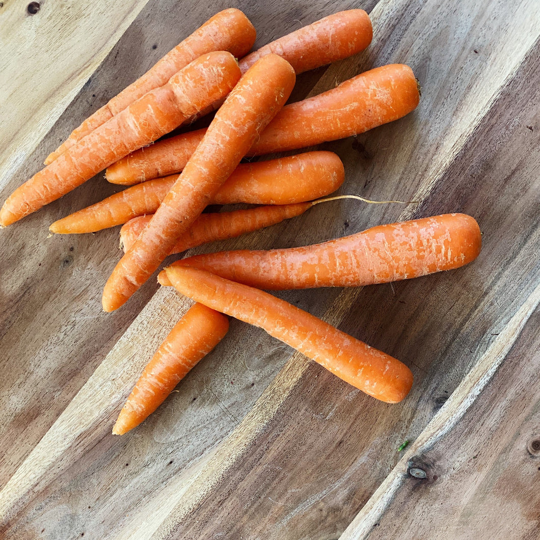 orange carrots on a wooden board