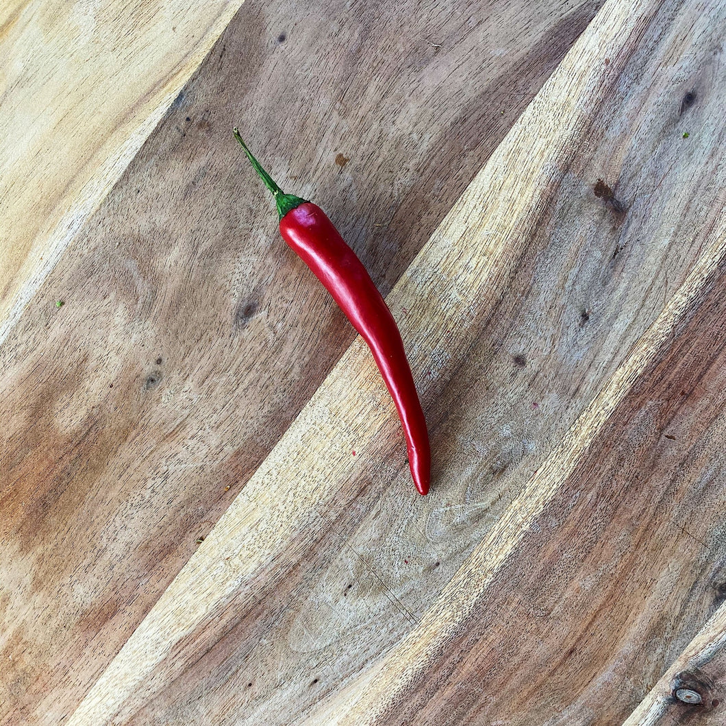 fresh red chilli on a wooden board