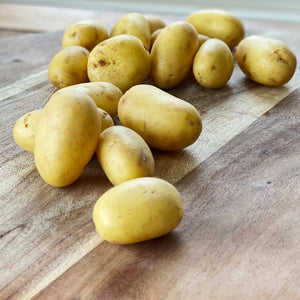 collection of new potatoes on a wooden board