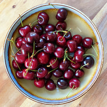 Load image into Gallery viewer, cherries in a bowl on a wooden board
