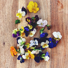 Load image into Gallery viewer, edible viola flowers on a wooden board

