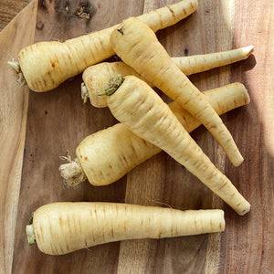 6 loose parsnips on a board