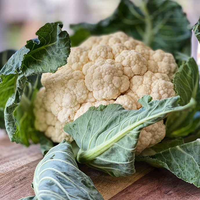 raw cauliflower on a wooden board