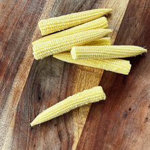 Load image into Gallery viewer, 7 baby sweetcorn on a wooden board
