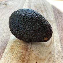 Load image into Gallery viewer, ripe hass avocado on a wooden board
