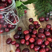 Load image into Gallery viewer, fresh cranberries on a wooden board and in a jar with foliage
