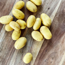 Load image into Gallery viewer, collection of new potatoes on a wooden board
