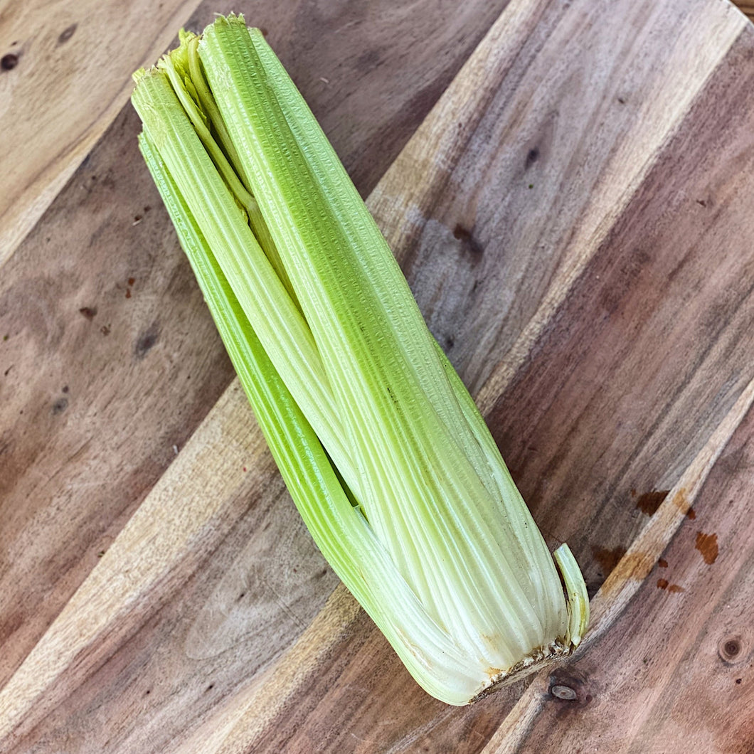 fresh celery on a wooden board