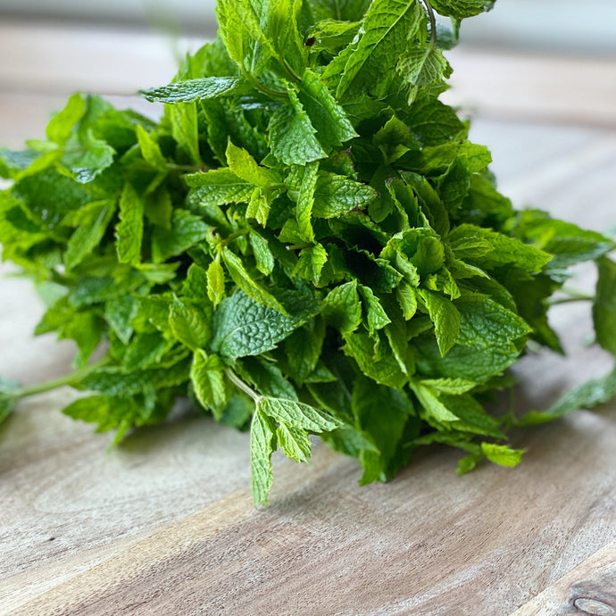 bunch of fresh mint on a wooden board