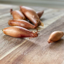 Load image into Gallery viewer, shallot onions on a wooden board
