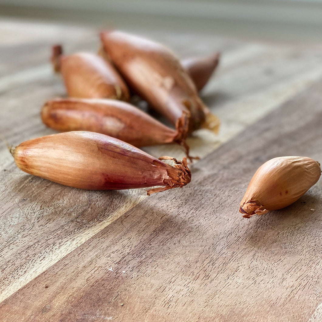 shallot onions on a wooden board
