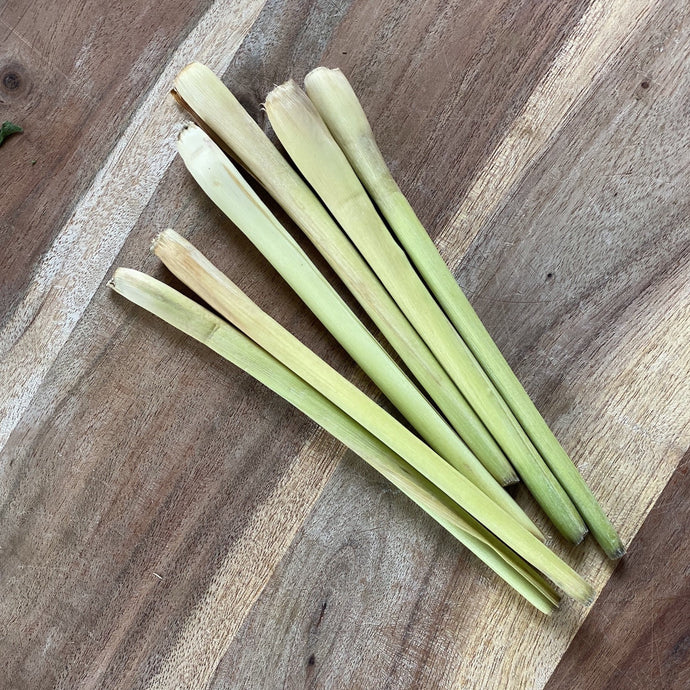 stalks of fresh lemongrass on a wooden board