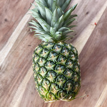 Load image into Gallery viewer, whole pineapple on a wooden board
