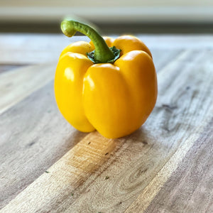 yellow pepper on a wooden board