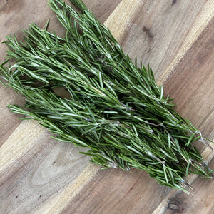 fresh bunch of rosemary on a wooden board