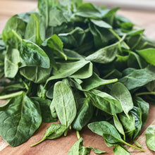 Load image into Gallery viewer, fresh baby spinach on a wooden board
