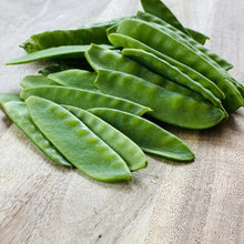 Load image into Gallery viewer, raw mange tout on a wooden board
