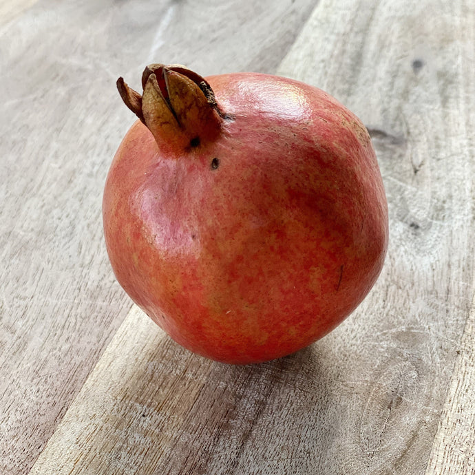 fresh pomegranate on a wooden board