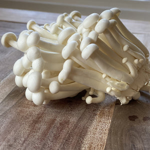 white beech mushrooms on a wooden board