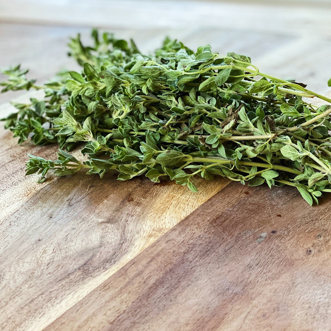 fresh marjoram herb on a wooden board
