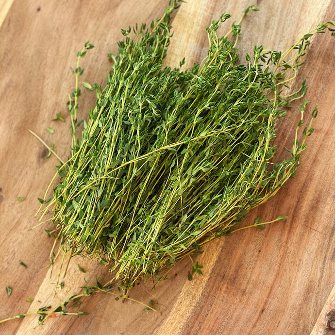 bunch of thyme on wooden board