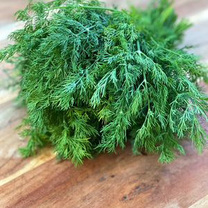fresh dill on a wooden board