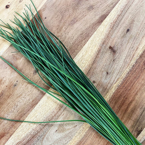 fresh chives on a wooden board