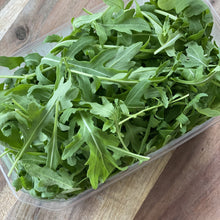 Load image into Gallery viewer, plastic punnet of rocket salad leaves on a wooden board
