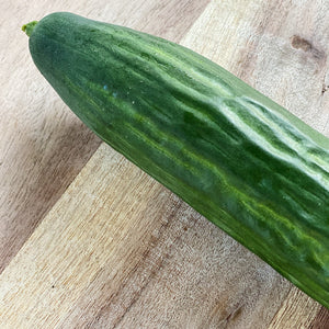 top of a cucumber on a wooden board