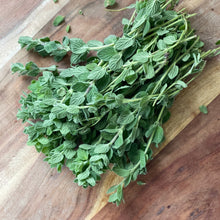 Load image into Gallery viewer, fresh oregano on a wooden board
