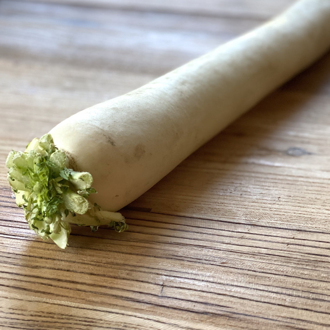 white radish mooli on a wooden board