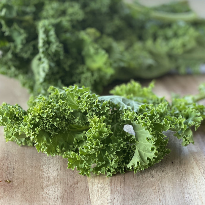 fresh kale on a wooden board