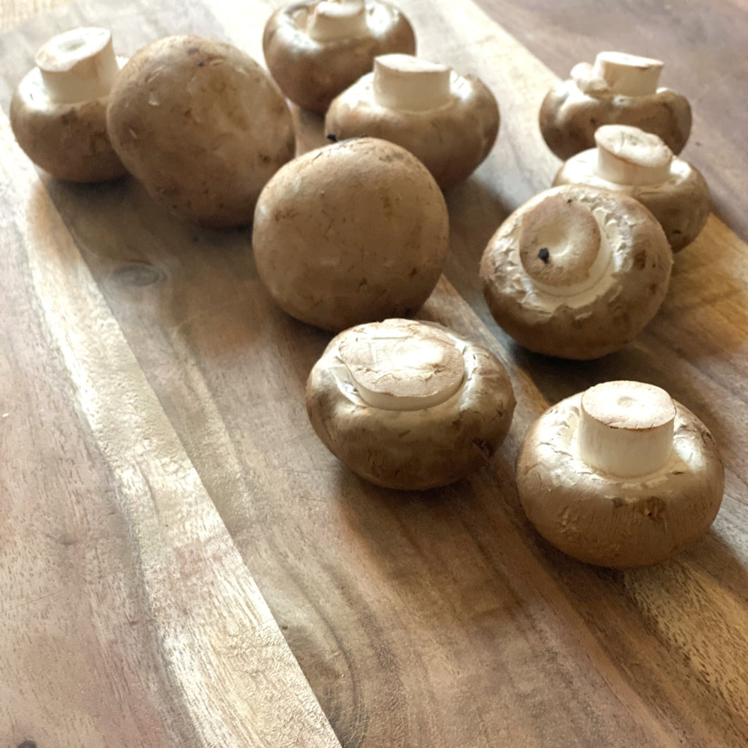 Chestnut mushrooms on a wooden board